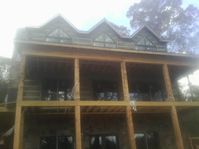 Dormers and porch framing on a large log home under construction in Crab Orchard
